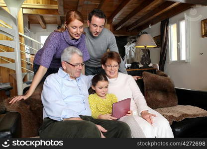 Young girl showing her family her laptop