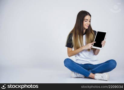 young girl showing something from tablet