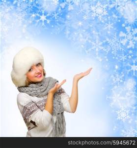 Young girl shows welcome gesture on blue winter background