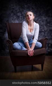 Young girl sit on chair at dark room