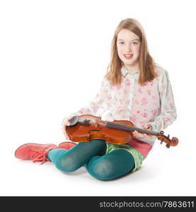 young girl sits in studio against white background and holds violin