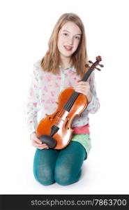 young girl sits in studio against white background and holds violin