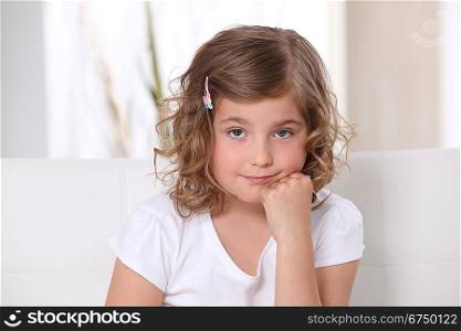 Young girl sitting on a sofa