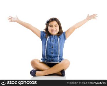 Young girl sitting on floor and using a tablet