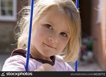 Young girl sitting on swing