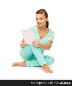 young girl sitting on the floor with tablet pc