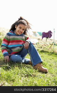 Young Girl Sitting Outside In Caravan Park