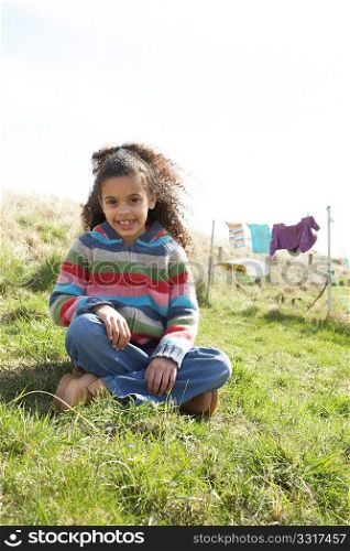 Young Girl Sitting Outside In Caravan Park