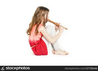 young girl sitting with soprano recorder and white background