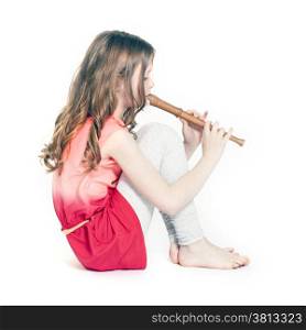 young girl sitting with soprano recorder and white background