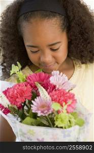 Young Girl Smelling A Bouquet Of Flowers