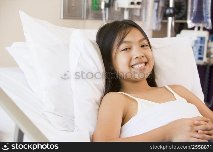Young Girl Smiling In Hospital Bed