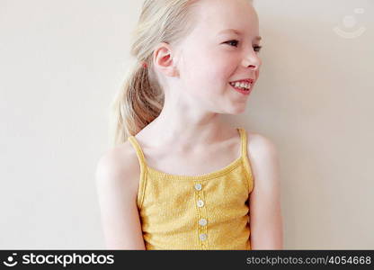 Young girl smiling, looking away