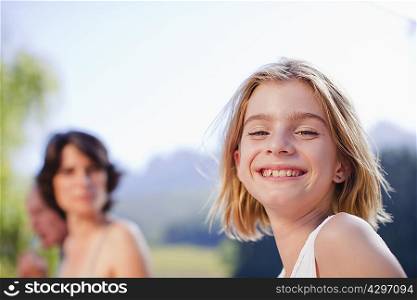 Young girl smiling outdoors