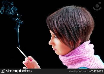 Young girl smoking on black