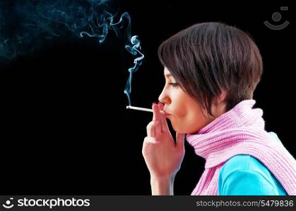 Young girl smoking on black