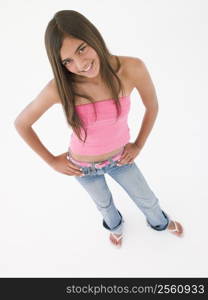 Young girl standing with hands on hips smiling