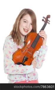young girl stands in studio against white background and holds violin