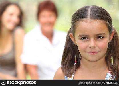 Young girl stood with family in background