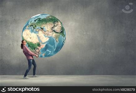 Young girl student carrying Earth planet. Elements of this image are furnished by NASA. Safe the planet