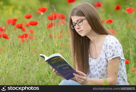 Young girl student reading a book