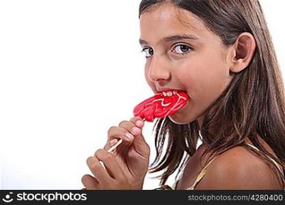 Young girl sucking on a lollipop