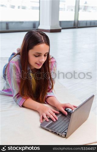 Young girl surfing internet on laptop