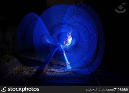Young girl surrounded by frozen light. Drawing with light. Long exposure. Artistic abstraction. Freezelight.. Young girl surrounded by frozen light. Drawing with light. Long exposure. Artistic abstraction. Freezelight