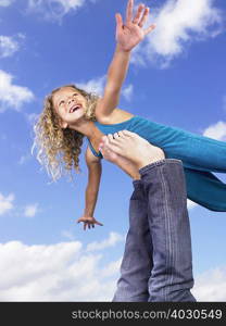 Young girl swirling feet in the air