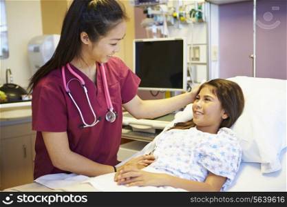 Young Girl Talking To Female Nurse In Hospital Room