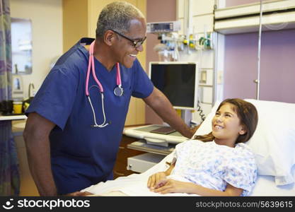 Young Girl Talking To Male Nurse In Hospital Room