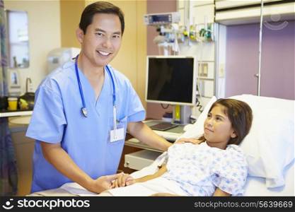 Young Girl Talking To Male Nurse In Hospital Room