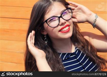 Young girl Teenager with a wooden fence, a trendy stylish portrait