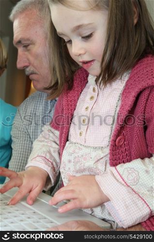 Young girl using a computer keyboard