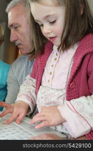 Young girl using a computer keyboard
