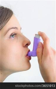 young girl using an inhalator, preventing a cold and respiration problems
