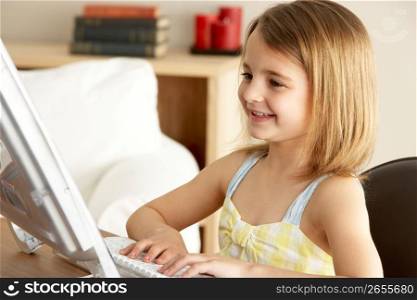 Young Girl Using Computer At Home
