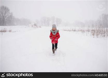 Young girl walking in snow