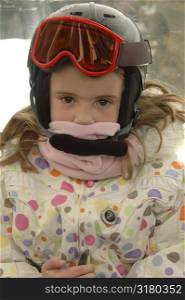 Young girl wearing a helmet and scarf