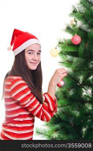 Young girl wearing beanie decorating christmas tree, eye contact, vertical shot