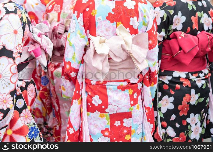 "Young girl wearing Japanese kimono standing in front of Sensoji Temple in Tokyo, Japan. Kimono is a Japanese traditional garment. The word "kimono", which actually means a "thing to wear" "