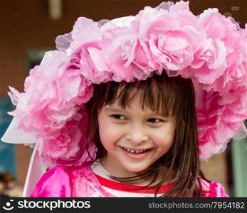 Young girl wearing pink flower hat