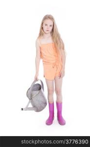 young girl wearing pink in studio with watering can