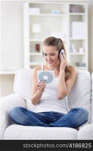 Young girl with a disk in his hands listening to music