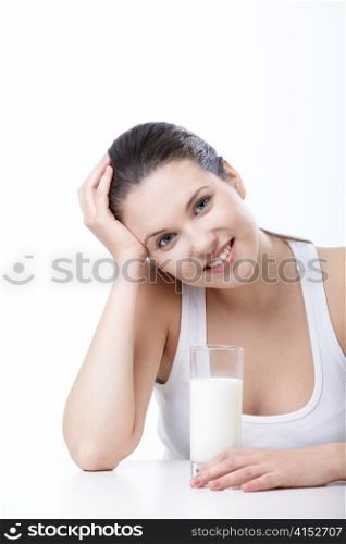 Young girl with a glass of milk on a white background