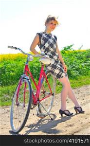 Young girl with a vintage bicycle
