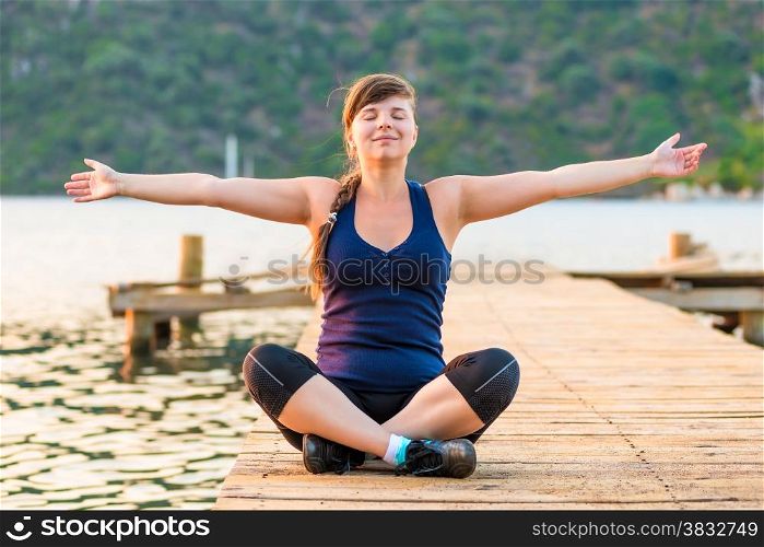 young girl with arms outstretched in the lotus position