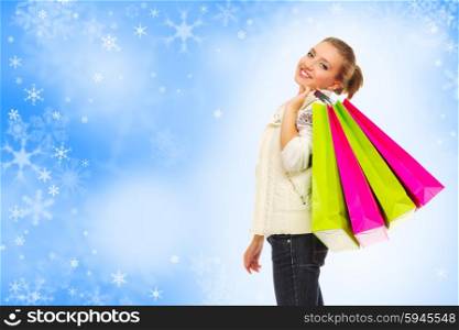 Young girl with bags on blue snowy background