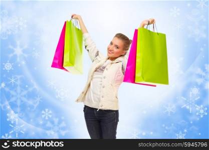 Young girl with bags on blue winter background