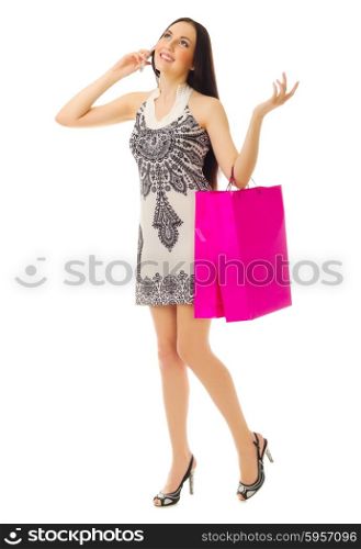 Young girl with bags talks by mobile phone isolated
